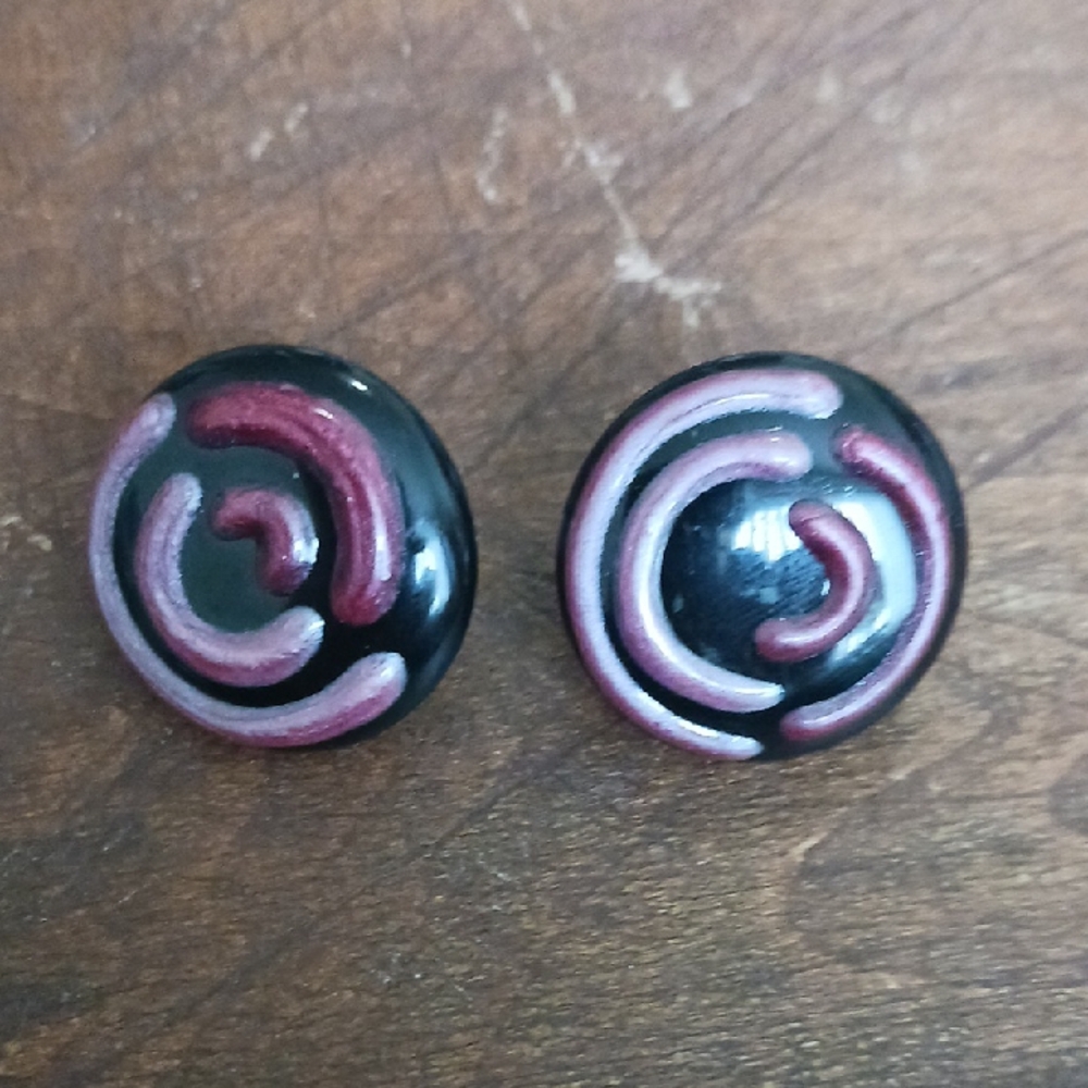 Round Black Clip-on  Earrings with Pink Swirl Detail.